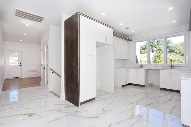 kitchen with white cabinetry and sink