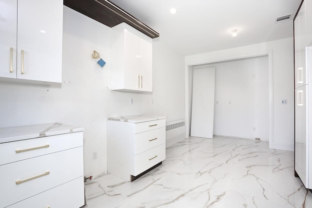 kitchen with white cabinets and light stone counters