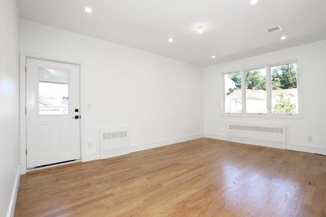 entryway with radiator and light hardwood / wood-style floors