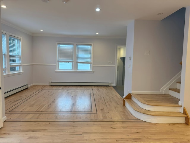 empty room featuring light hardwood / wood-style flooring, ornamental molding, and baseboard heating