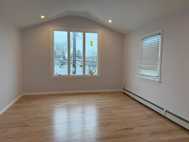 bonus room with a baseboard radiator, plenty of natural light, lofted ceiling, and light hardwood / wood-style flooring