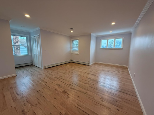 unfurnished room featuring light wood-type flooring, ornamental molding, and baseboard heating