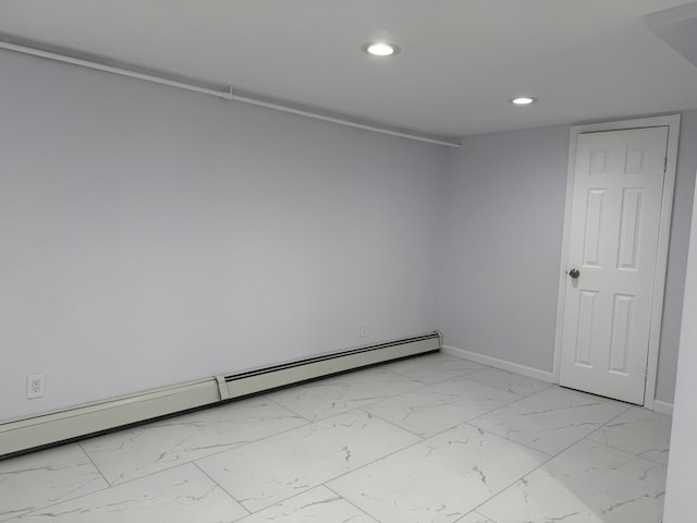 unfurnished room with baseboard heating