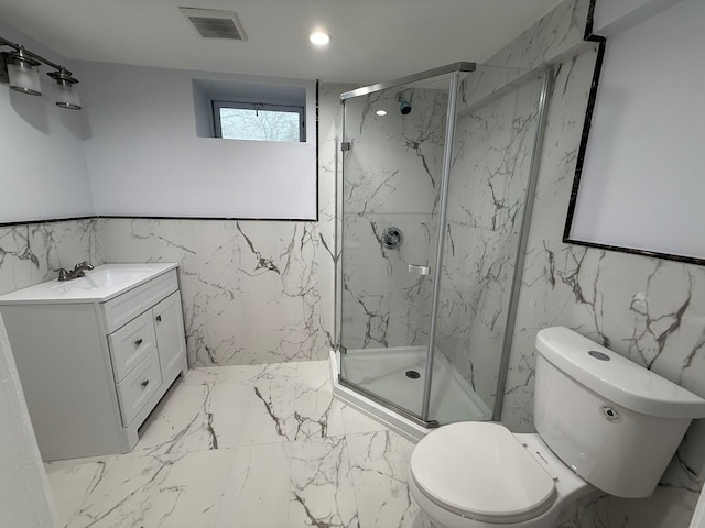 bathroom featuring vanity, toilet, and a shower with door