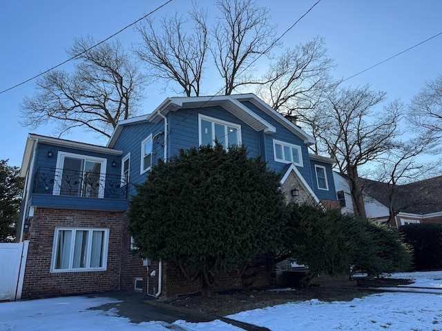 view of snow covered exterior featuring a balcony