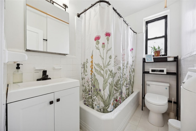 bathroom with toilet, tile patterned flooring, tile walls, and shower / tub combo with curtain