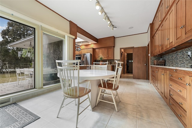 dining space featuring light tile patterned floors