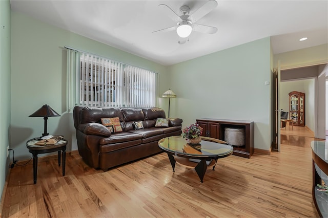 living room with ceiling fan and light wood-type flooring