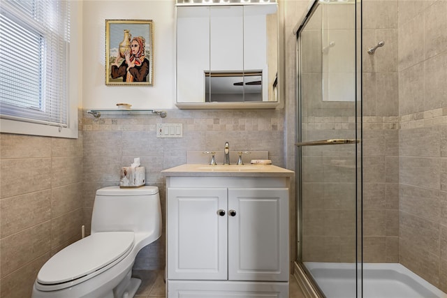 bathroom featuring vanity, toilet, tile walls, and walk in shower