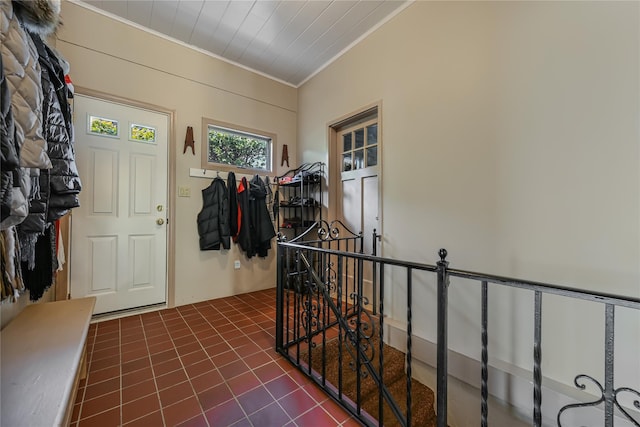 tiled foyer featuring ornamental molding