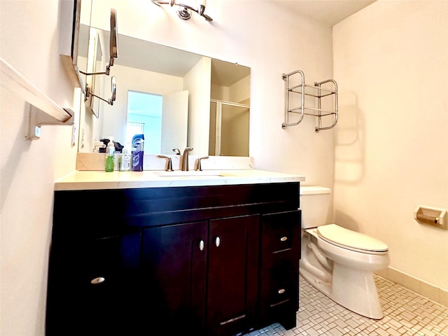 bathroom with tile patterned floors, vanity, toilet, and a shower with door