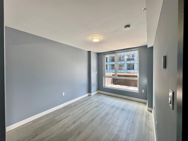 unfurnished room with light hardwood / wood-style floors