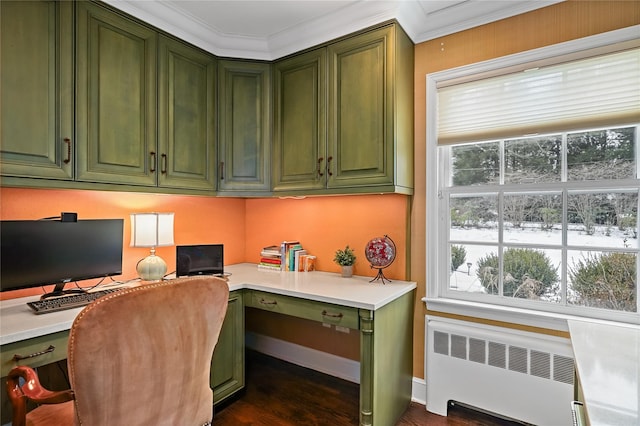 office space featuring baseboards, built in study area, radiator, dark wood finished floors, and crown molding