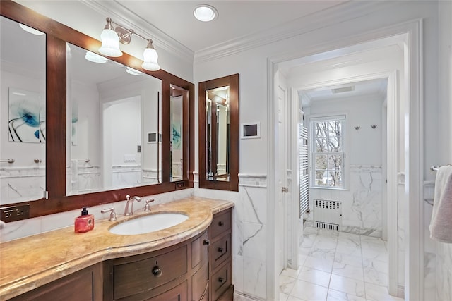 bathroom featuring wainscoting, radiator heating unit, marble finish floor, crown molding, and vanity