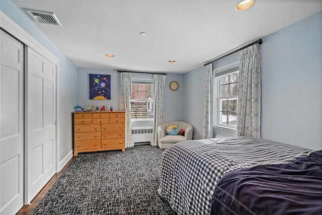 bedroom featuring radiator, multiple windows, visible vents, and recessed lighting