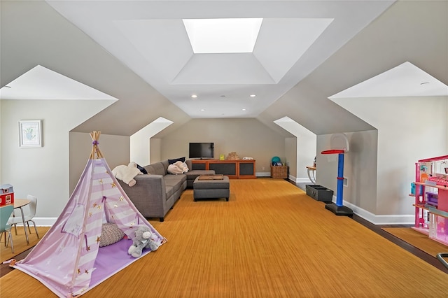 playroom featuring vaulted ceiling with skylight, recessed lighting, and baseboards