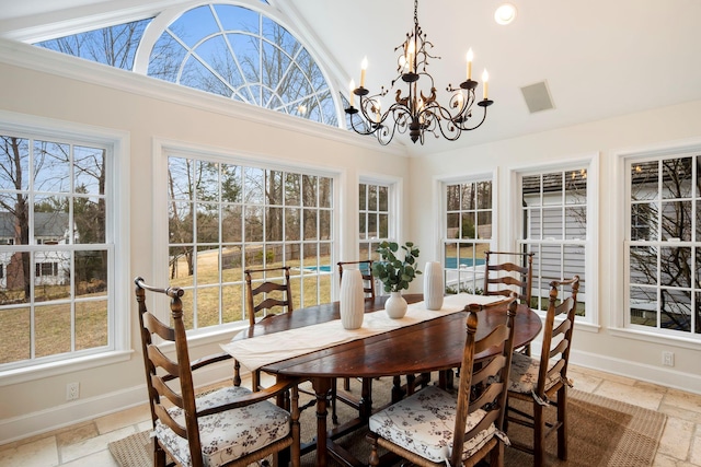 dining space featuring recessed lighting, stone tile flooring, baseboards, and an inviting chandelier