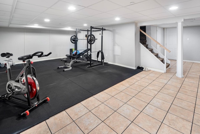 workout room featuring recessed lighting, a drop ceiling, and baseboards