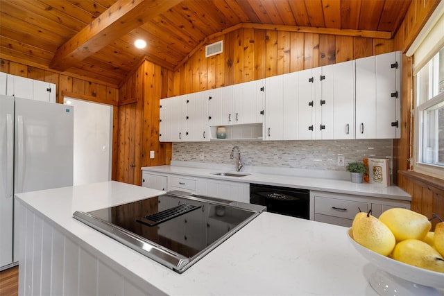 kitchen with lofted ceiling with beams, black dishwasher, visible vents, and a sink