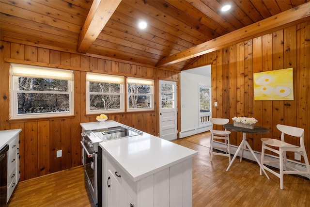 kitchen featuring high end stainless steel range oven, light wood-style floors, white cabinets, light countertops, and wood ceiling