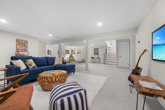 living room featuring recessed lighting, light colored carpet, and stairs