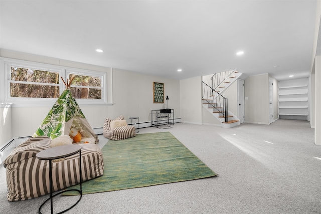 sitting room featuring baseboard heating, recessed lighting, stairs, and carpet floors