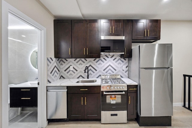 kitchen with dark brown cabinets, stainless steel appliances, sink, and decorative backsplash