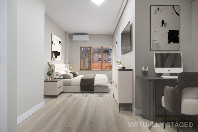 bedroom with light hardwood / wood-style flooring and an AC wall unit