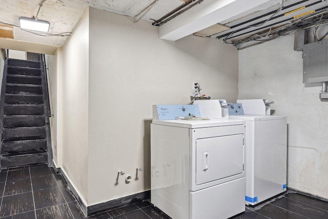 clothes washing area with dark tile patterned flooring and washing machine and dryer