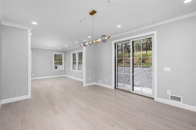 empty room featuring ornamental molding, wood finished floors, and baseboards