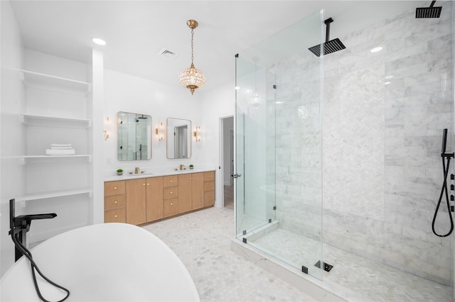 bathroom with double vanity, visible vents, a soaking tub, a shower stall, and a sink