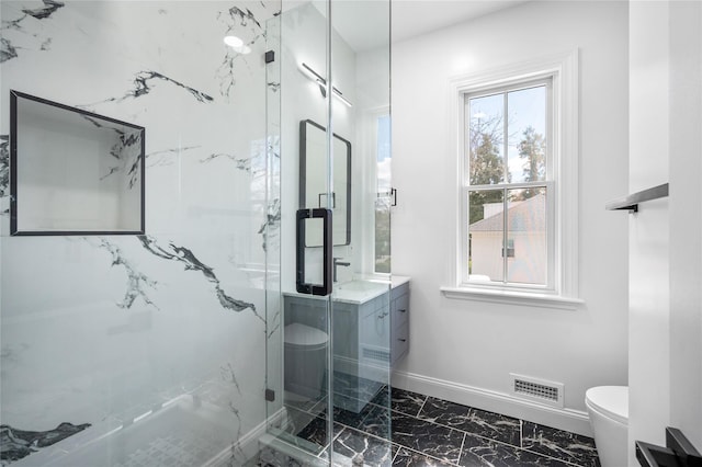 bathroom with toilet, visible vents, vanity, marble finish floor, and a marble finish shower