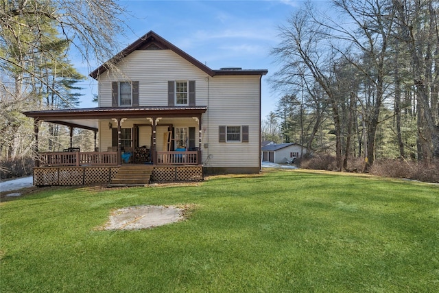 back of property with a lawn and a porch