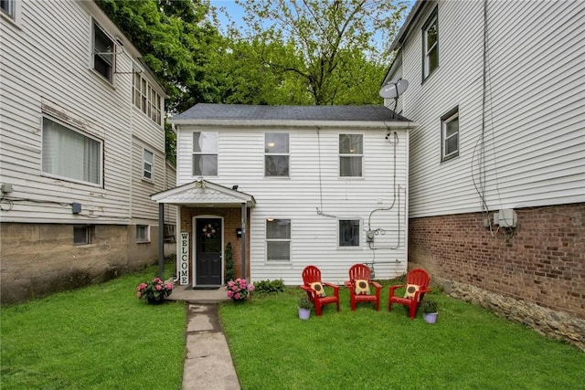 rear view of house with a yard