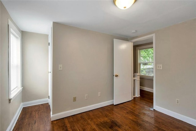 unfurnished bedroom featuring baseboards and wood finished floors