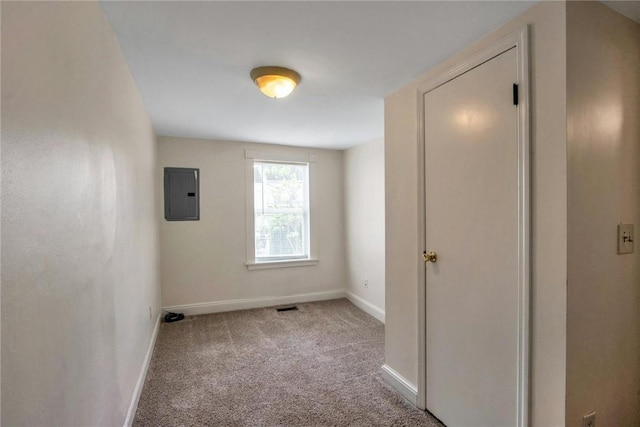 unfurnished bedroom featuring visible vents, electric panel, carpet, and baseboards