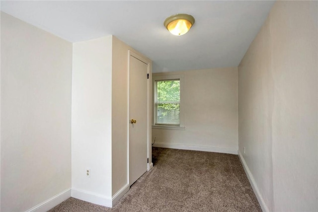 empty room with carpet and baseboards