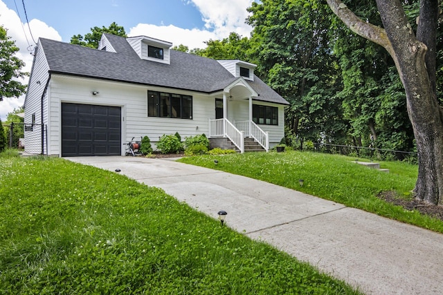 cape cod home with a garage, concrete driveway, roof with shingles, fence, and a front yard