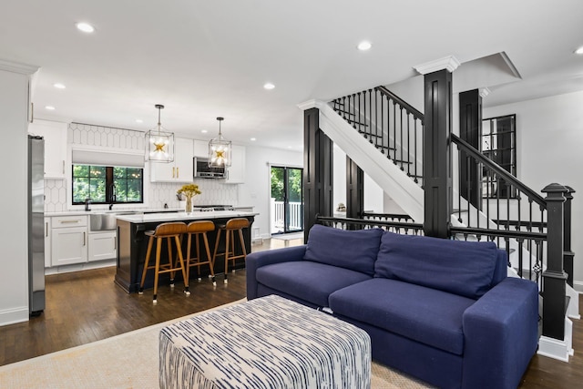 living room featuring stairway, dark wood finished floors, a wealth of natural light, and recessed lighting