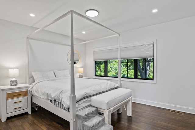 bedroom with recessed lighting, visible vents, baseboards, and wood finished floors