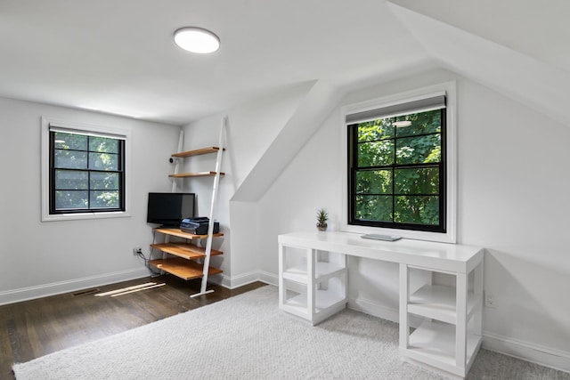 office with lofted ceiling, wood finished floors, visible vents, and baseboards