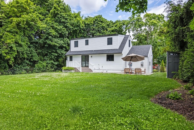 view of front of home featuring a front lawn, a shingled roof, and fence