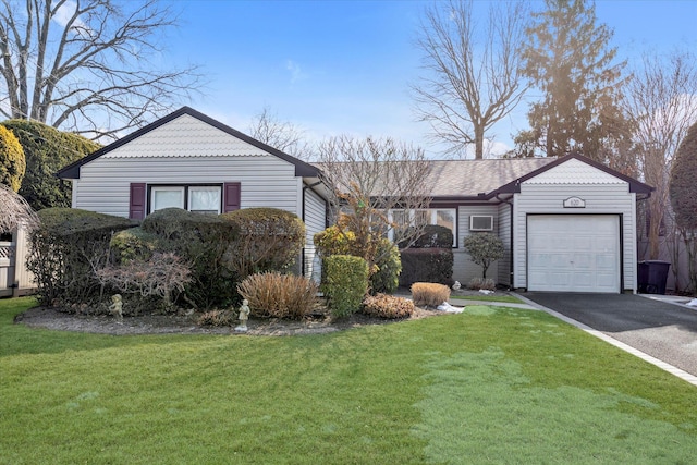 ranch-style home with a front lawn, driveway, and an attached garage