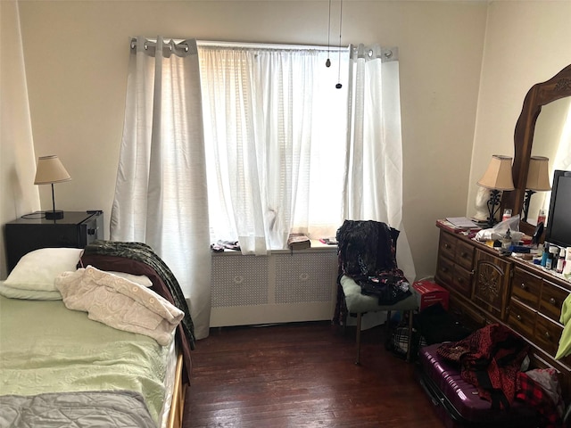 bedroom featuring dark hardwood / wood-style flooring