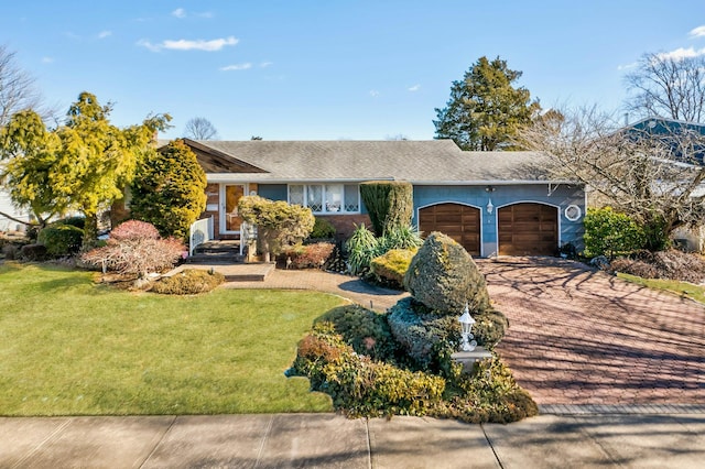 single story home featuring a garage and a front yard