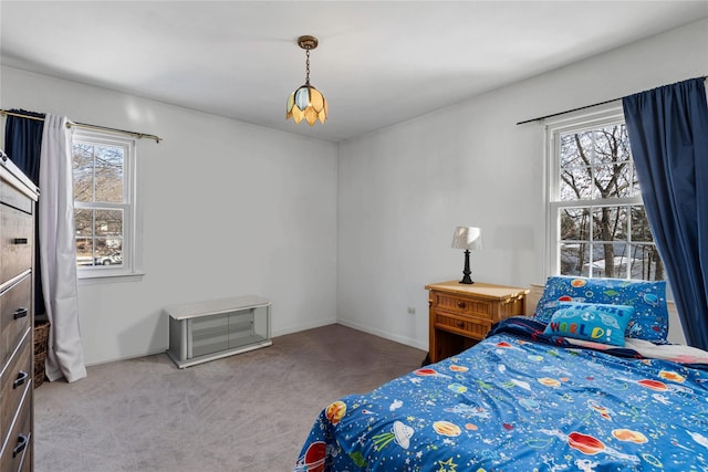 bedroom featuring carpet floors and multiple windows