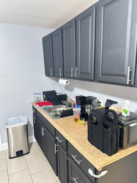 kitchen featuring sink and light tile patterned floors