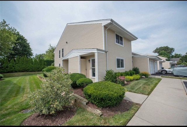 view of property exterior with a garage and a yard