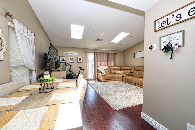 2355 Pershing Blvd Unit 712, Baldwin, NY 11510 - living room featuring dark hardwood / wood-style flooring and vaulted ceiling with skylight