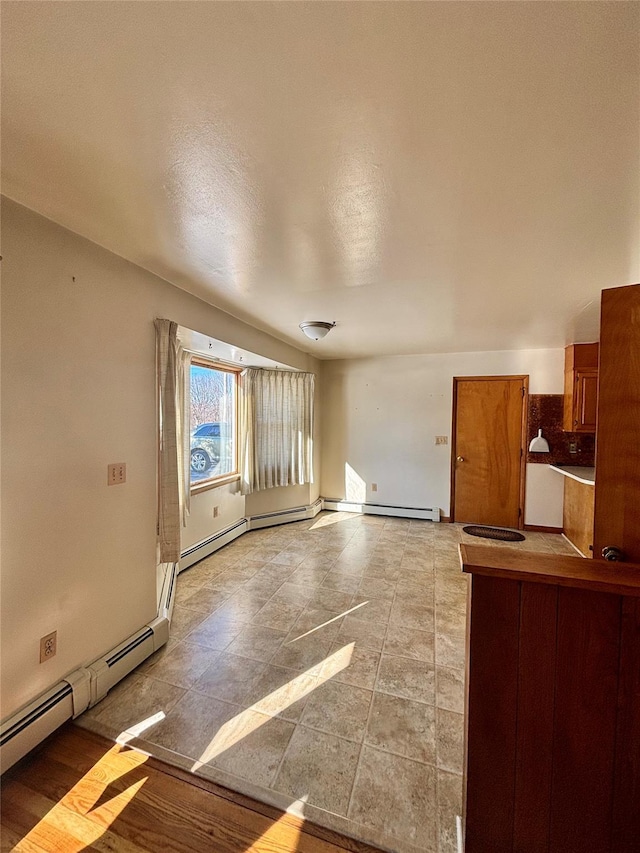 unfurnished living room featuring a baseboard radiator